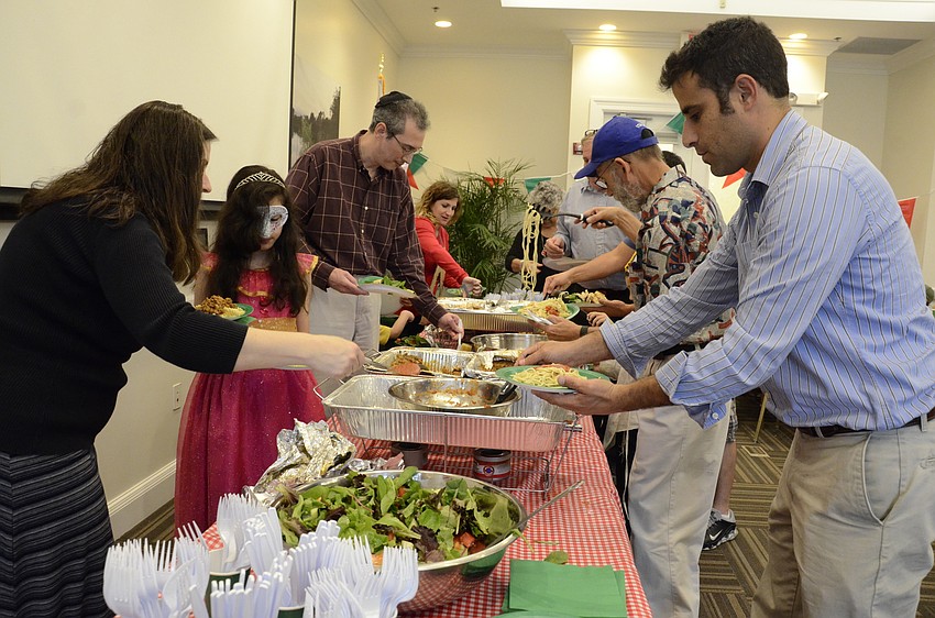 Celebration attendees load up on homemade Italian fare.