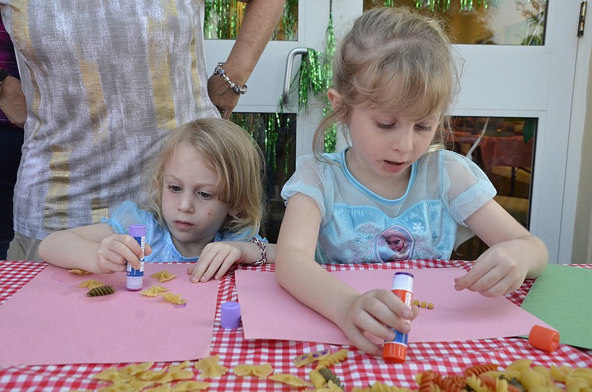 Molly and Madeline Gursh make pasta collages with help from grandma Patti Gursch.