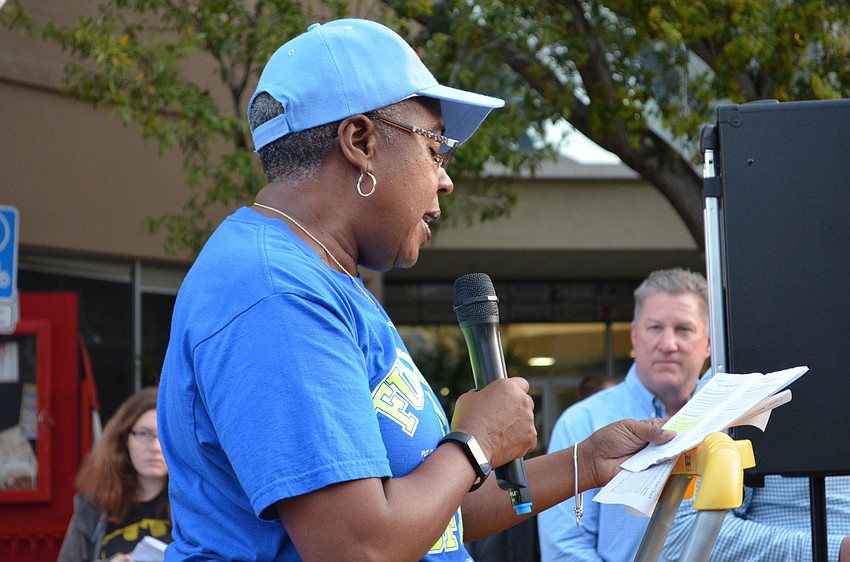 Sarasota County Commissioner Carolyn Mason reads scripture during one of the stops during the Station of Cross.