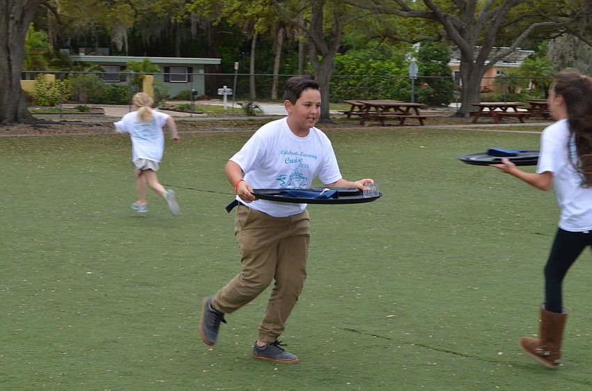 Guliano Gastou races across the yard in the No Waiting hospitality relay race.