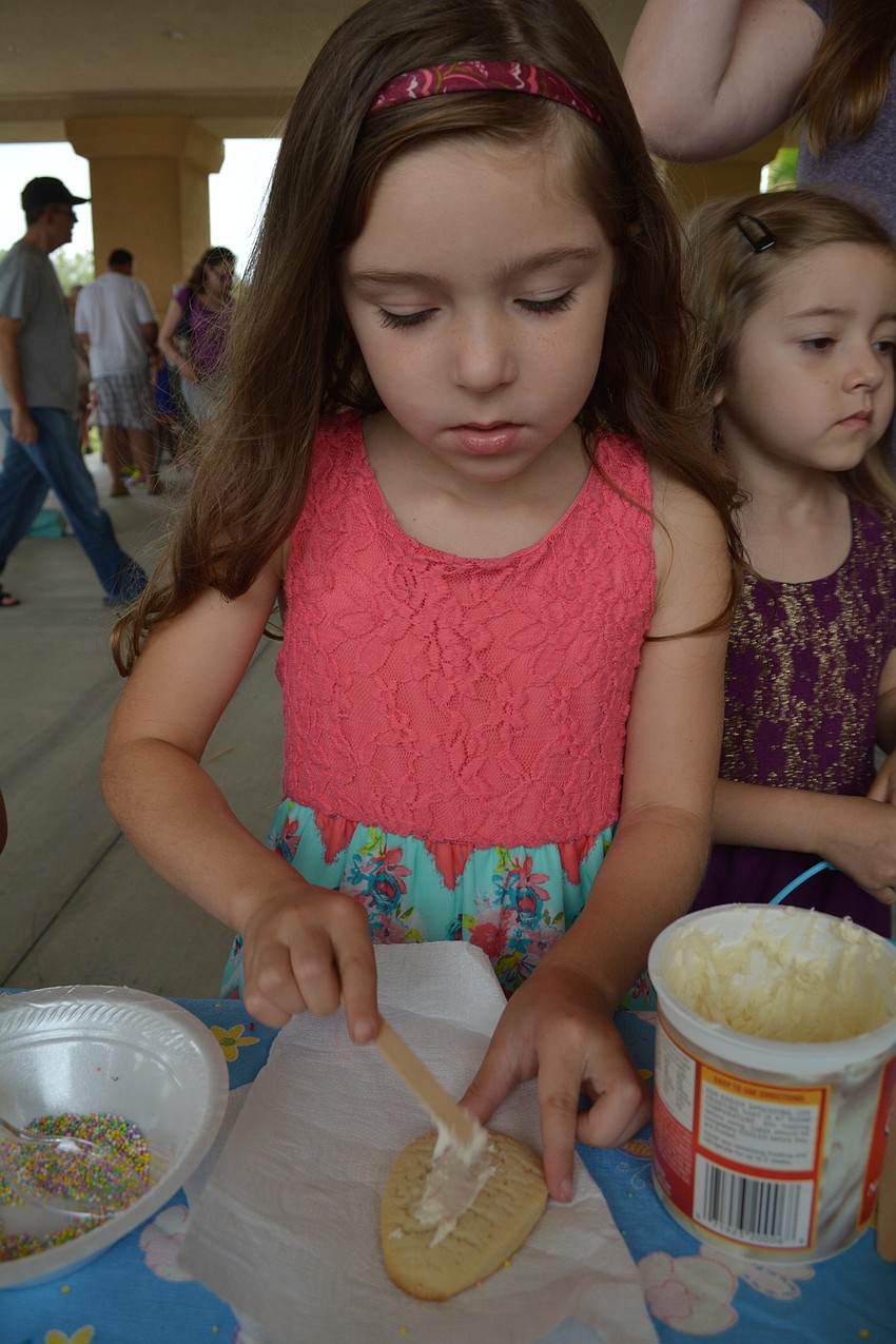 Emma Andersen, 6, decorates a cookie before the hunt.