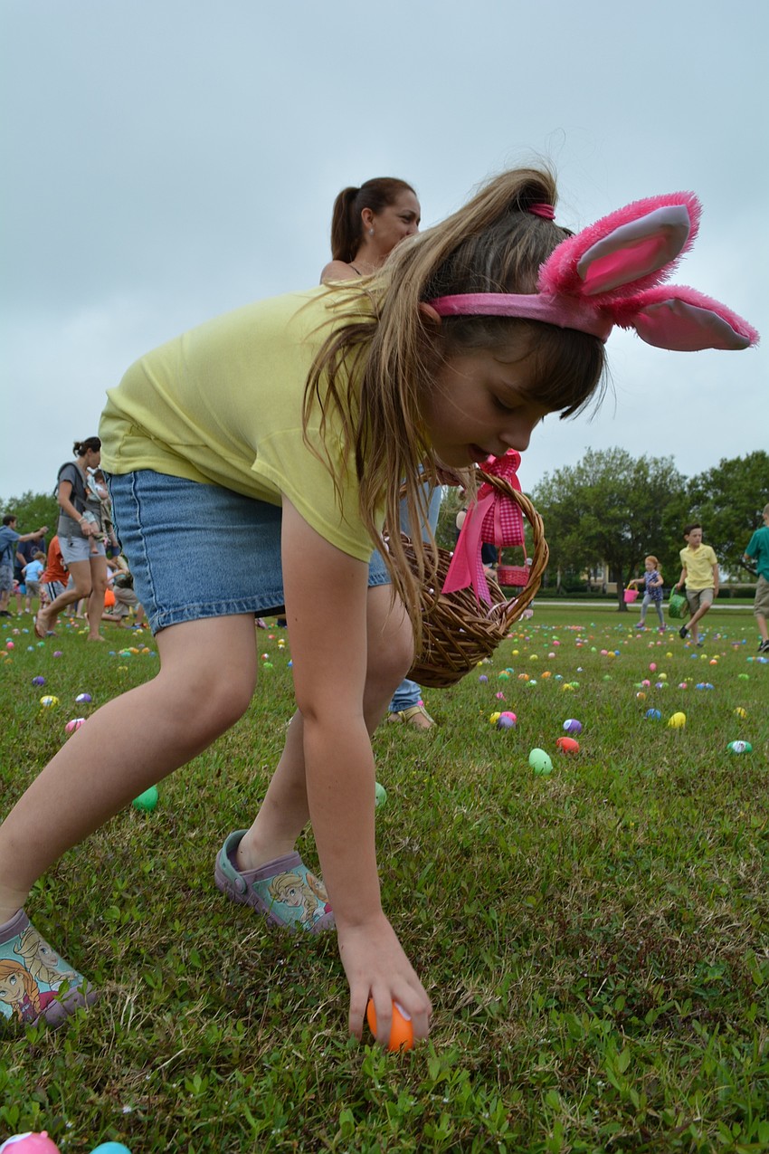 Alice Barr, a student at Braden River Elementary, dashes for eggs.