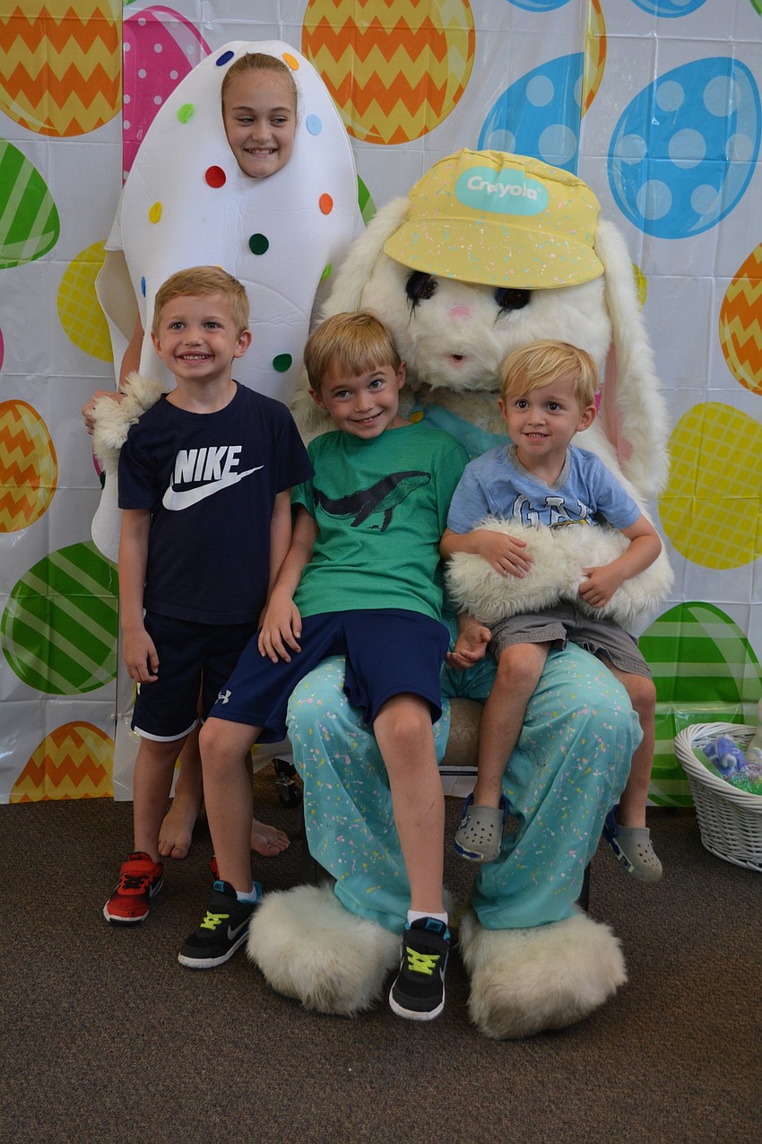 Drew, Noah and Ryan Sirianni, of Lakewood Ranch, pose with the Easter Bunny and an Easter egg (Lily Dunn).