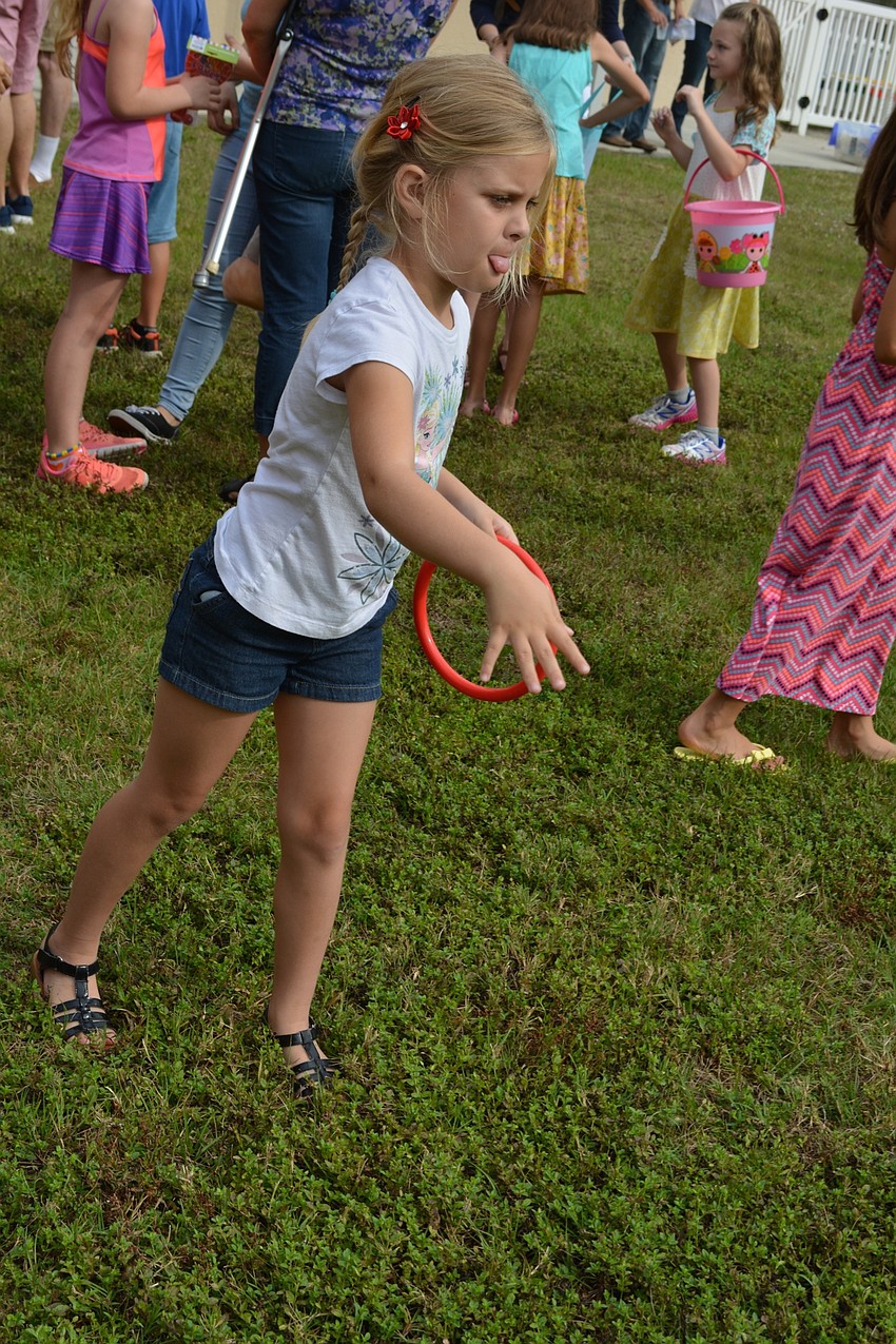 Madison Lane, 5, tries her hand at the ring toss.