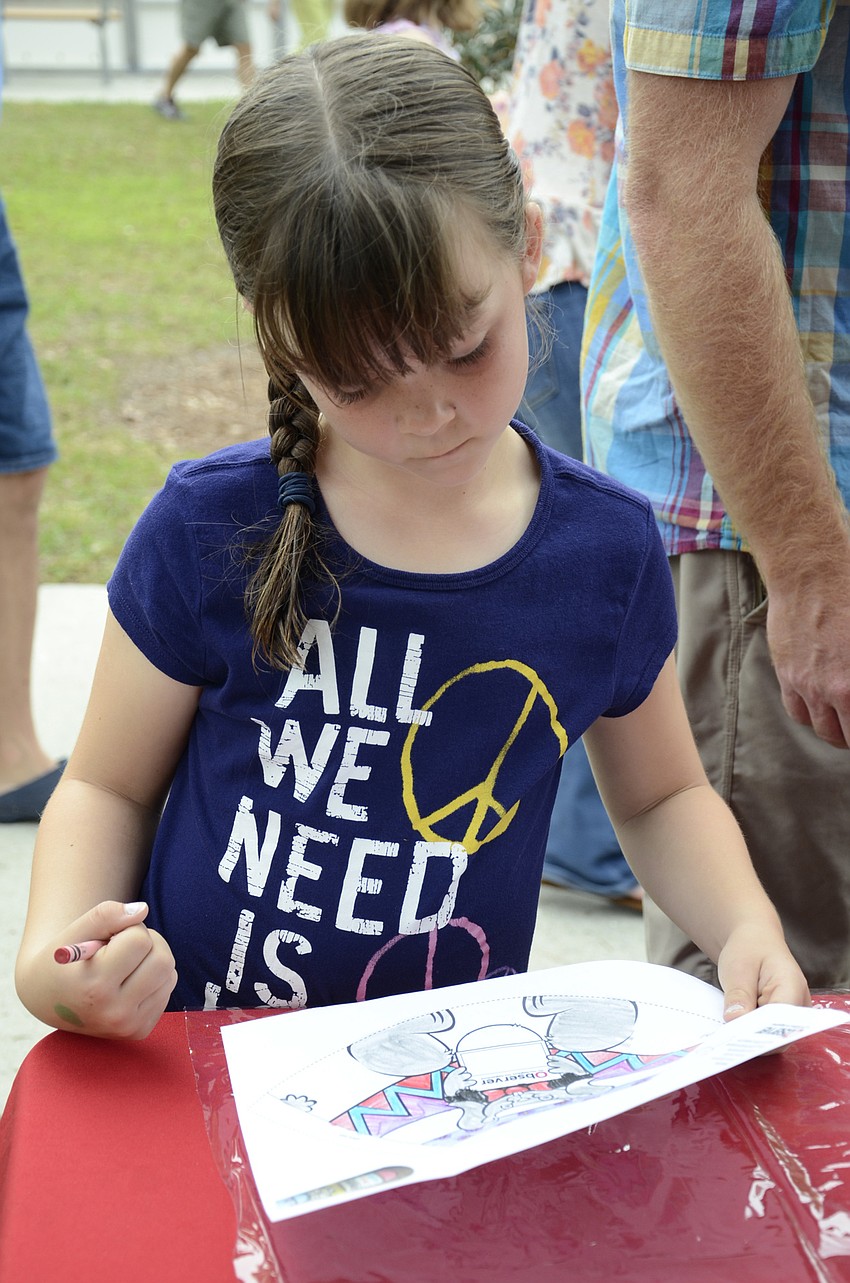 Cate Kitcher of Lakewood Ranch examines her artwork.