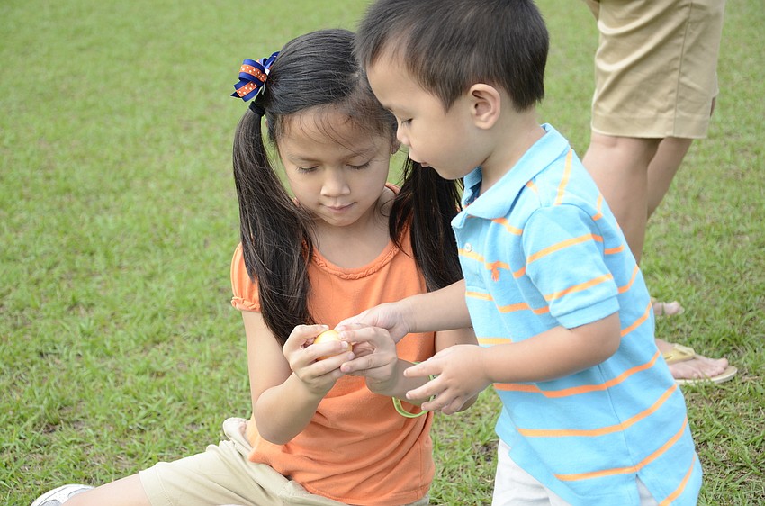 Adriana and Andon Nazario of Lakewood Ranch investigate the candy in the eggs.