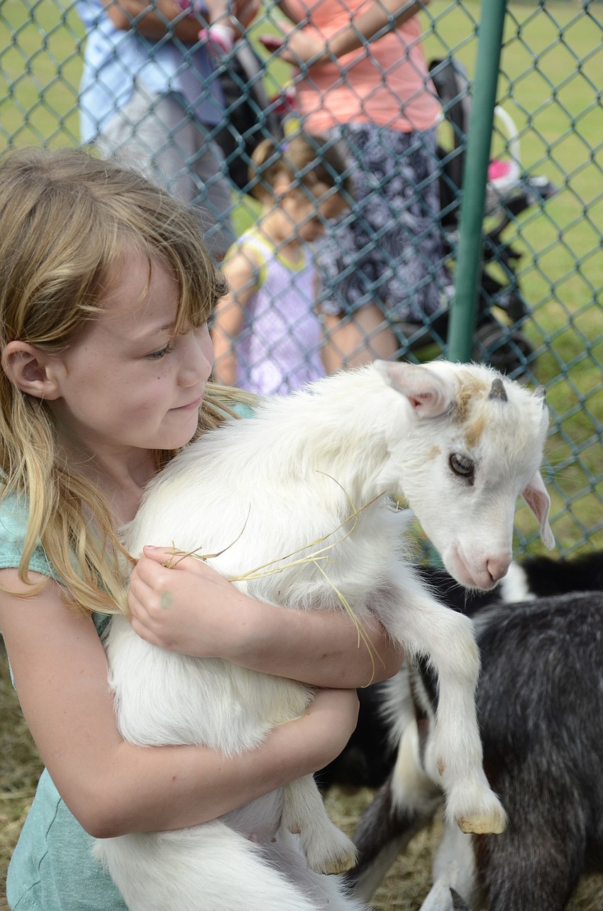 Sadie Jackson of Lakewood Ranch holds a kid of the goat variety.