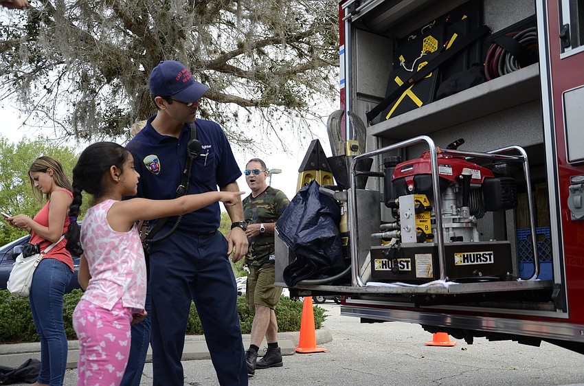 Tanvi Mathura of Lakewood Ranch asks Stephen Beecher, a firefighter at the East Manatee Fire Station, about the fire truck.