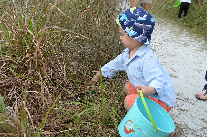 Lorenzo Calderon spots an egg in the bushes.