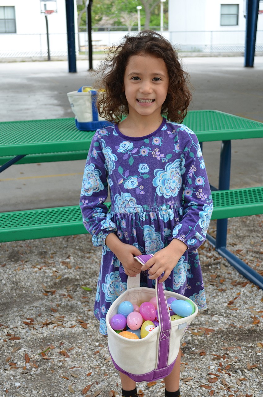 Beatrice DeGuzman is proud of the many eggs she gathered.