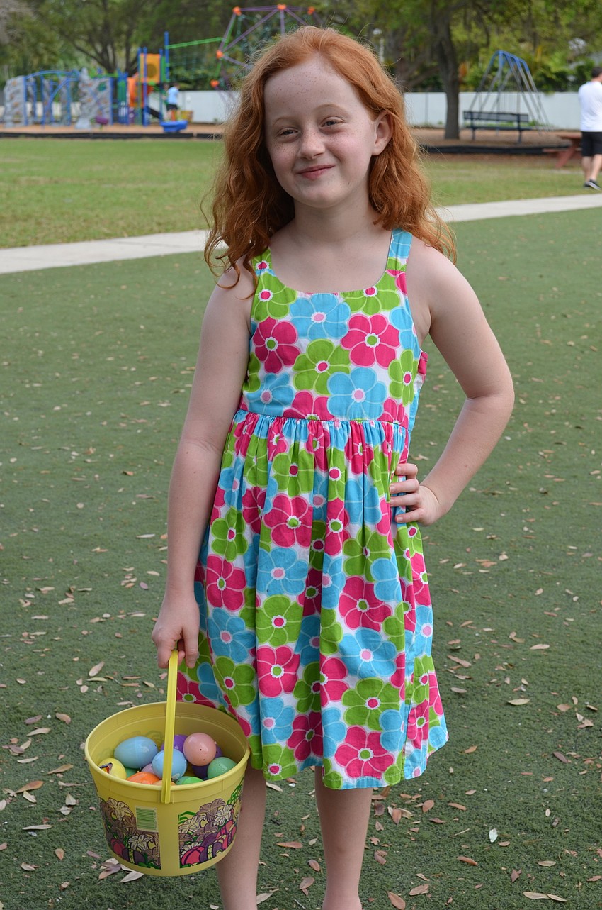 Madison Taylor shows off her Easter dress and basket full of eggs.