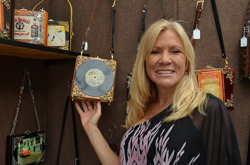 Elaine Laurent with one of her handbags made from a re-purposed cigar box.