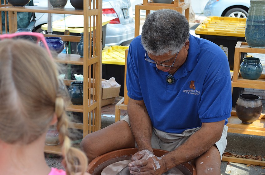 Artists Ricardo Hicks starts work on wet clay.