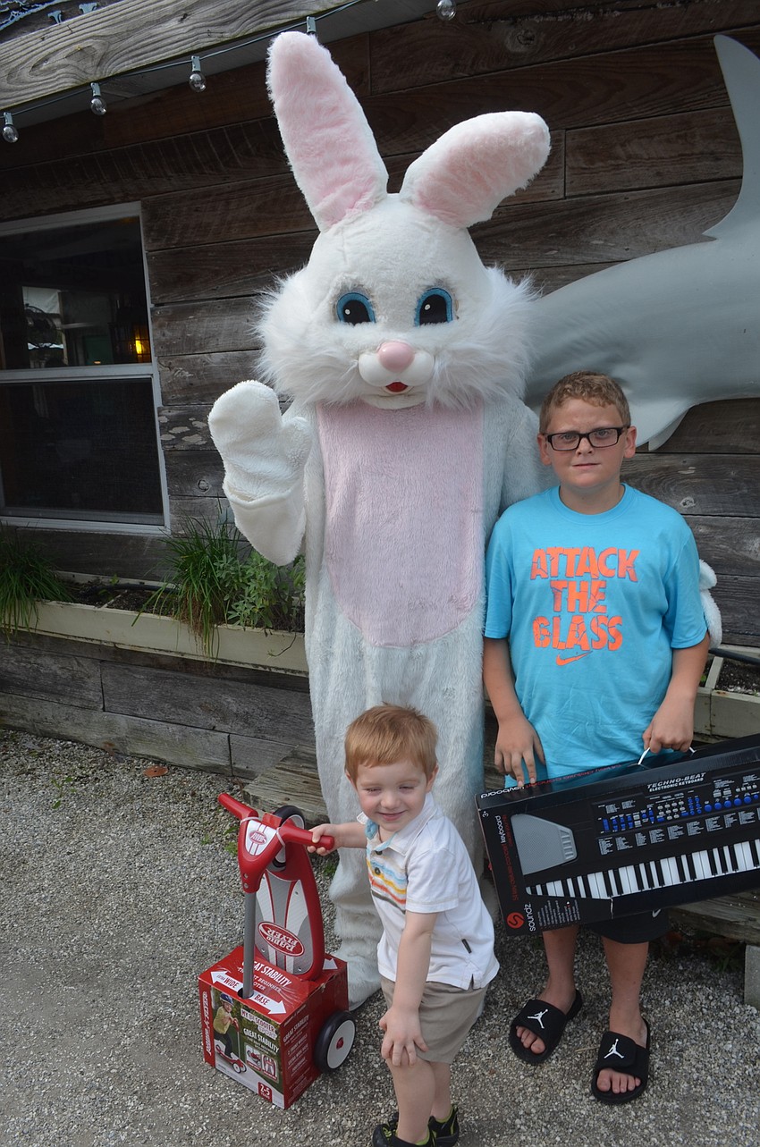 Prize winners Isaac Cole, 2, and Kale Petrin, 10, with the Easter Bunny