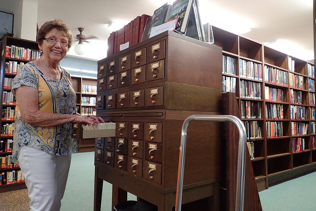 Library volunteer Linda Weiss works with the card catalogue, one of the features many love about the library.