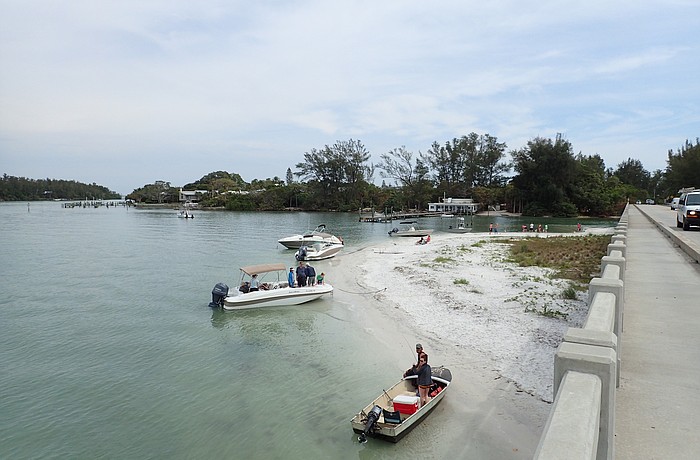 Boaters line Beer Can Island on March 25, despite the cloudy weather. On sunnier days, larger crowds of boaters anchor both on Beer Can Island and near Jewfish Key to the east of the Longboat Pass Pridge.