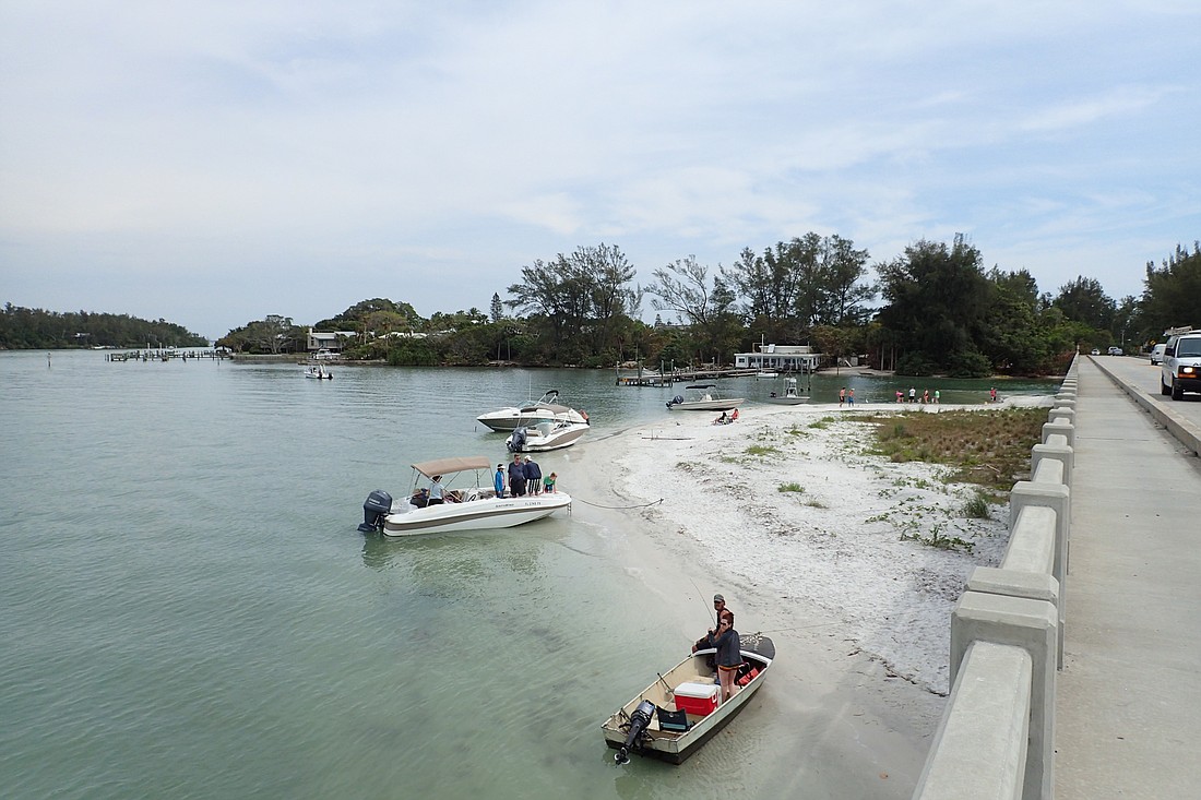 Boaters line Beer Can Island on March 25, despite the cloudy weather. On sunnier days, larger crowds of boaters anchor both on Beer Can Island and near Jewfish Key to the east of the Longboat Pass Pridge.