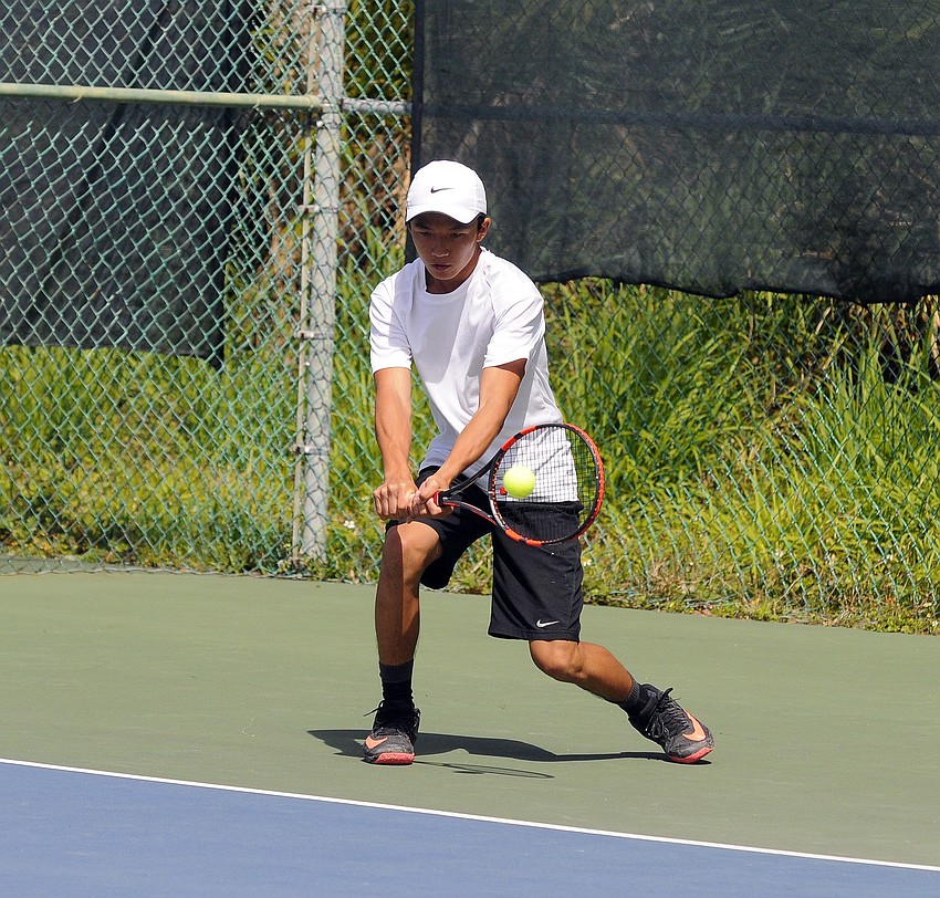 Sarasota's Anh Tran warms up before his No. 2 double quarterfinal match.