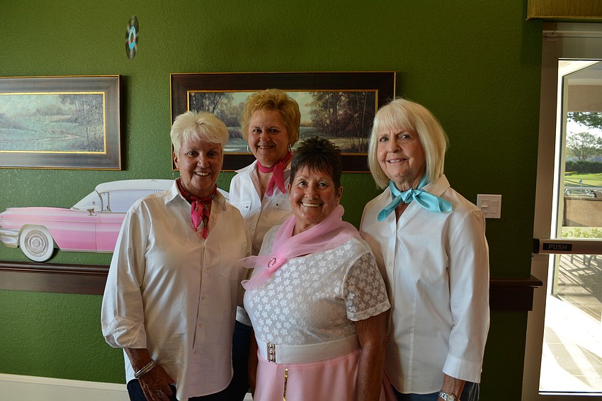 Nancy Nagy, Shirley Krieger, Donna Breeden and Kaye Kuzell want a photo by the pink Cadillac.