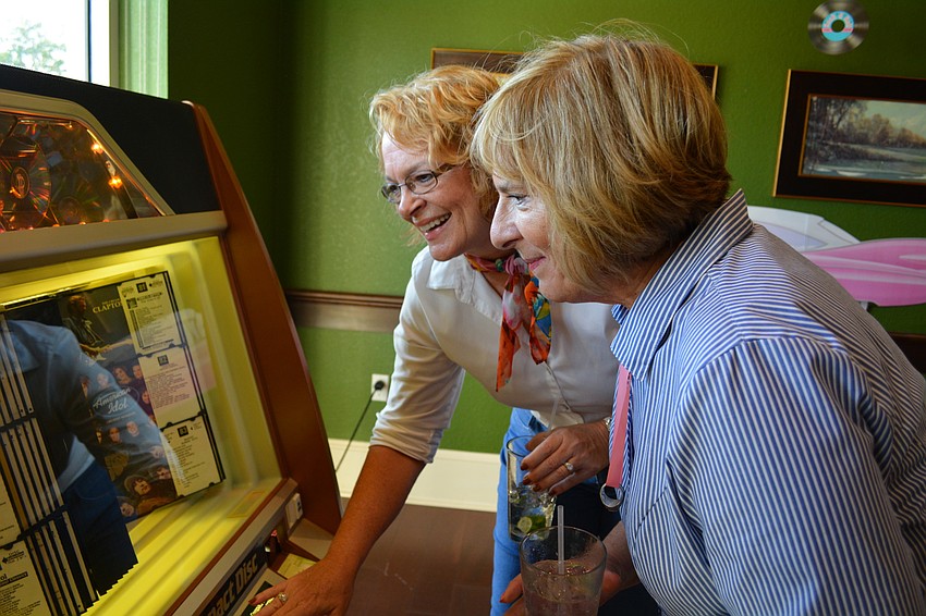 Melanie Mihocik and Valarie Evanko check out their music options on the juke box.