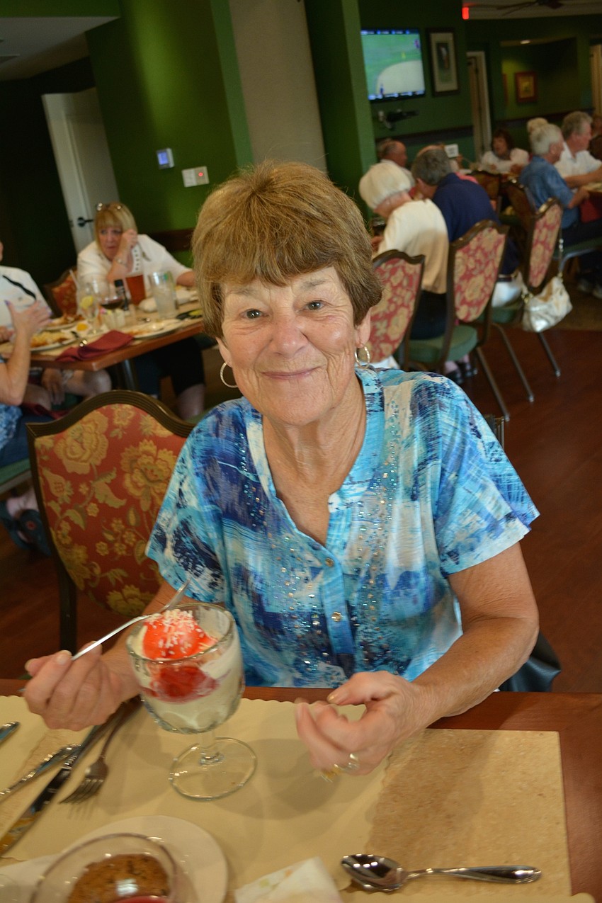 Fran Duckworth topps her sundae with strawberries and coconut.