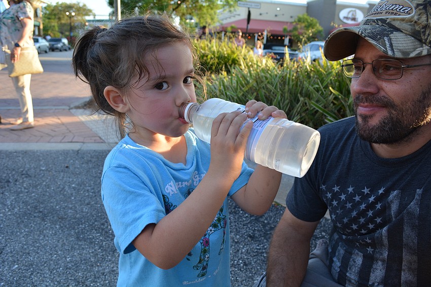 Lakewood Ranch's Nova Ayling, 3, gets a drink of water from her dad, Matt, after dancing.