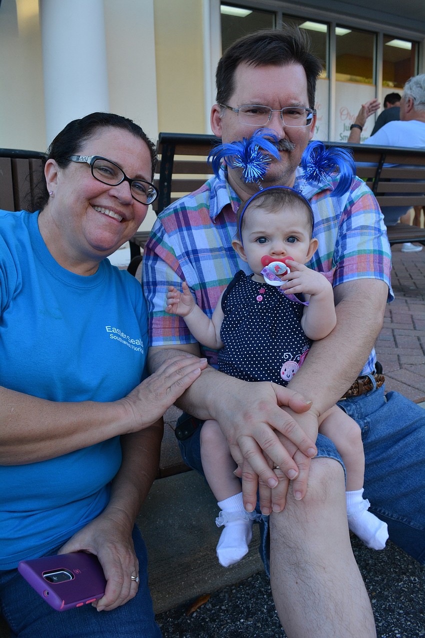 Kathy and Douglas Reinbolt, of Bradenton, hold their granddaughter, Chloe Cook.