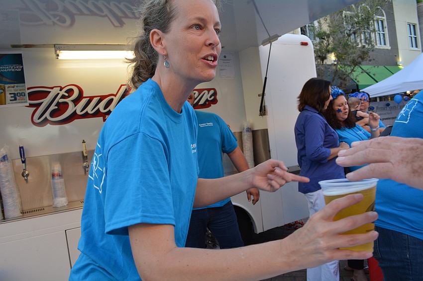 Volunteer Jeannine Ryan serves beer for Easter Seals, the benefiting charity.