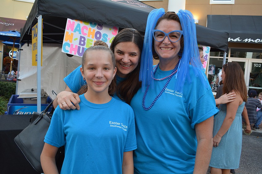 Odelia and Victoria Tiutyama, of Sarasota, pose with Robin Tucker, of Nokomis.