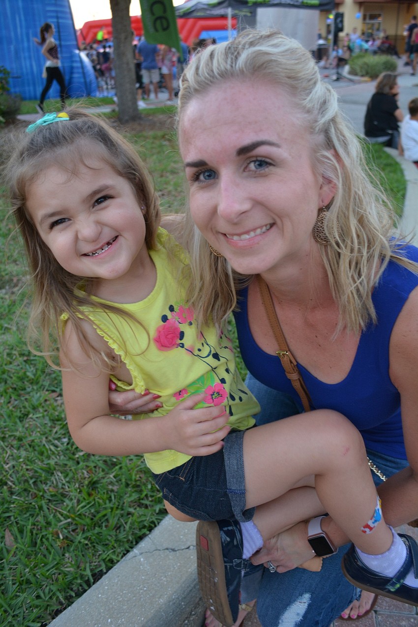 Harper Misiewicz, 3, hops in the lap of her mother, Lyndsey.