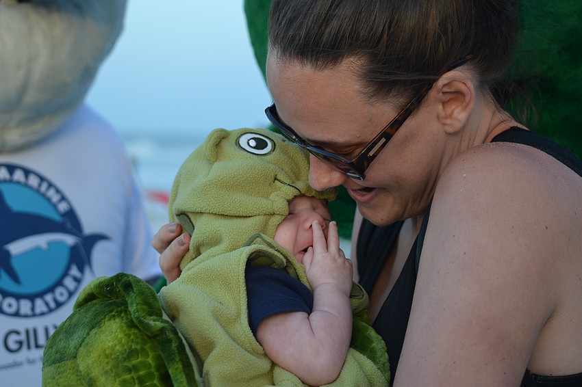 Ten-week old hatchling Connor with his mother Jamie Jalwan. She is a former Mote  employee and bought the costume before Connor was born with this event in mind. Jalwan also bought a costume the next size up for him to don next year.