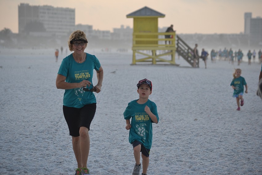 Denise Sanders and Carson Searer ran side by side during the one-mile fun run/walk.