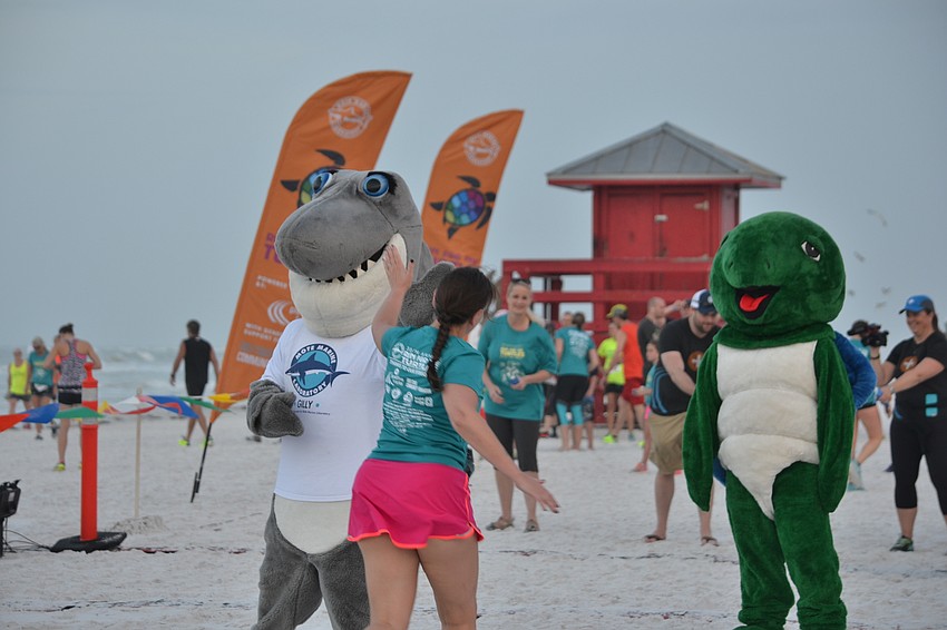 Gilly the shark and Shelley the turtle greet participants as they cross the finish line.