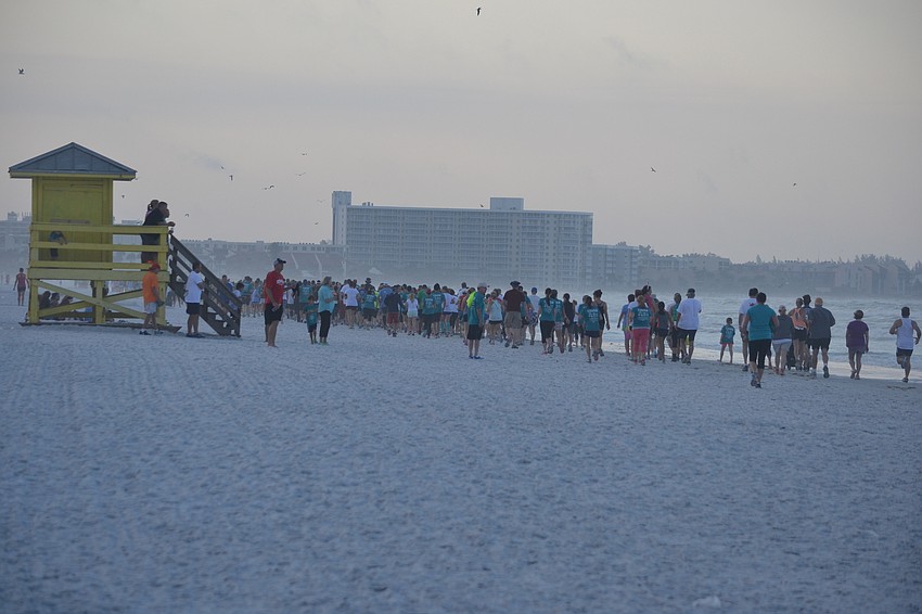 Runners make their way down the shore for the 30th annual Mote Run for the Turtles on Siesta Key Beach.