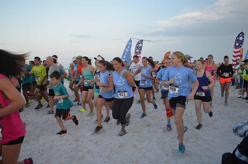 Participants take off after the start of the 30th annual Mote Run for the Turtles on Siesta Key Beach.