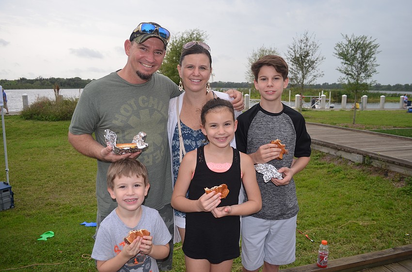 The Capecchi family — Aaron, Cassie, A.J., Emily and Max — enjoy burgers and hot dogs.