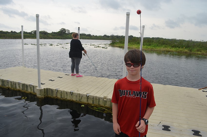 Nine-year-old Patrick Lowery, of East County, find a spot to fish on the dock.