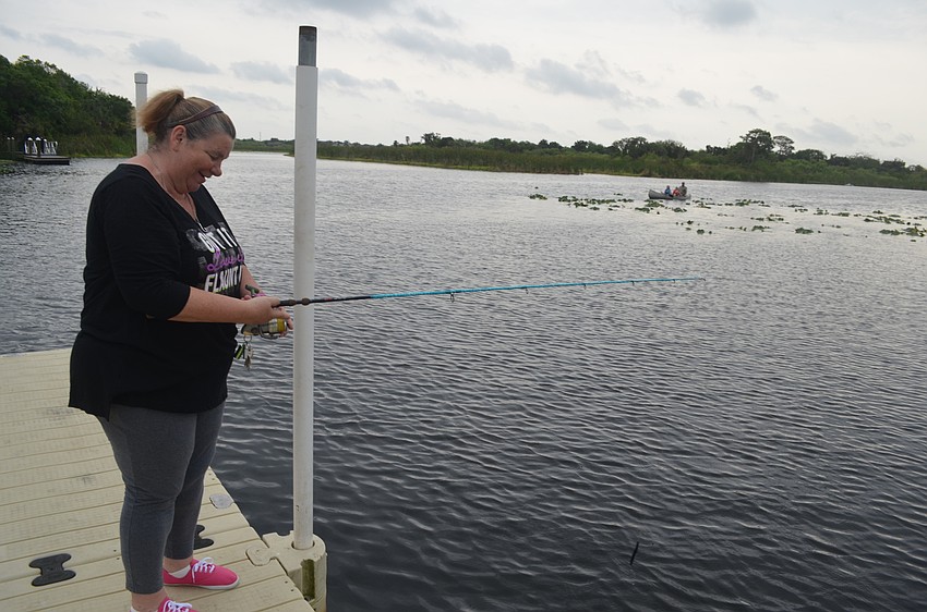 Liz Cruz, of Bradenton, casts her fishing line out into the water.