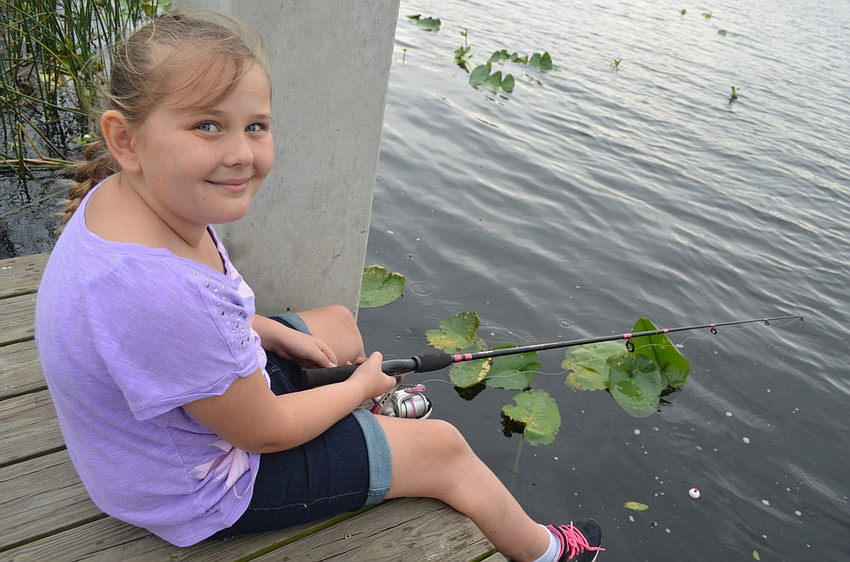 Bailey Williams, of Bradenton, relaxes on the dock while waiting for a fish to bite.