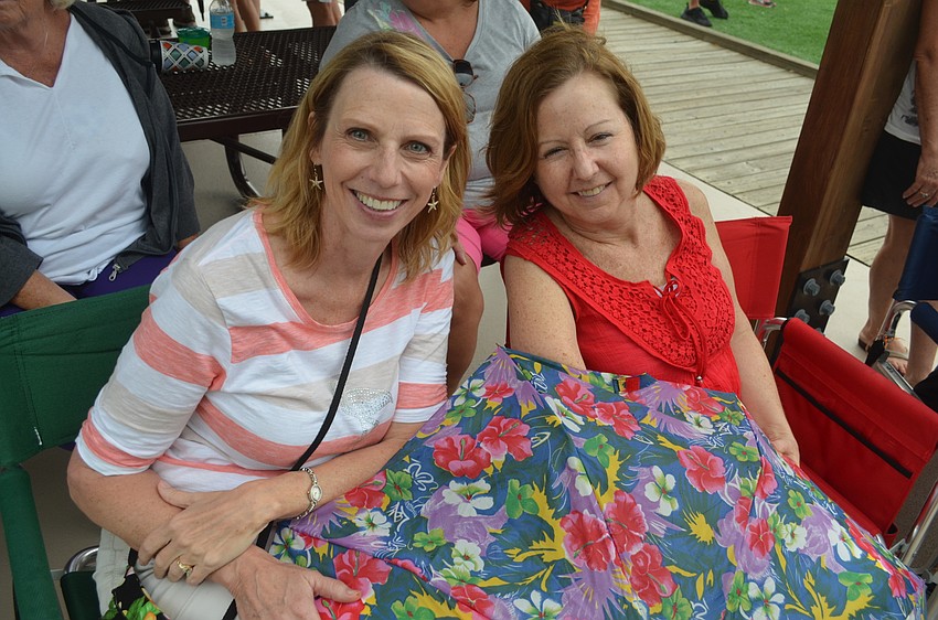 Cheryl Flynn and Terri Mayer, of East County, enjoy an afternoon outside, despite the afternoon storm.