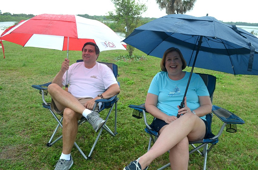 Ken and Lorraine Salazar, of East County, don't let the rain dampen their afternoon outside.