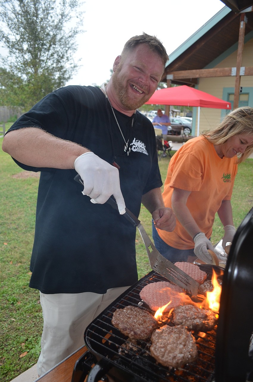 Travis Tinder, of Bradenton, cooks up burgers and hot dogs for a hungry crowd.