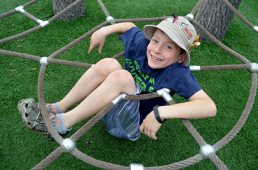 T.J. Besterman, of East County, looks uncomfortable, but spends much of the afternoon relaxing on the playground.