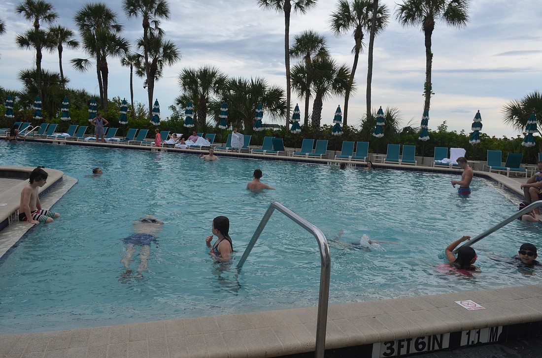 Guests enjoy an evening by the pool at the Resort at Longboat Key Club.