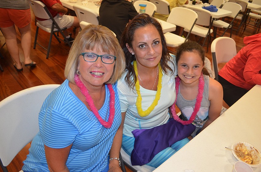 Vickie Winfield, Marguerite Pasquale and Isabella Pasquale spend time with neighbors and friends.