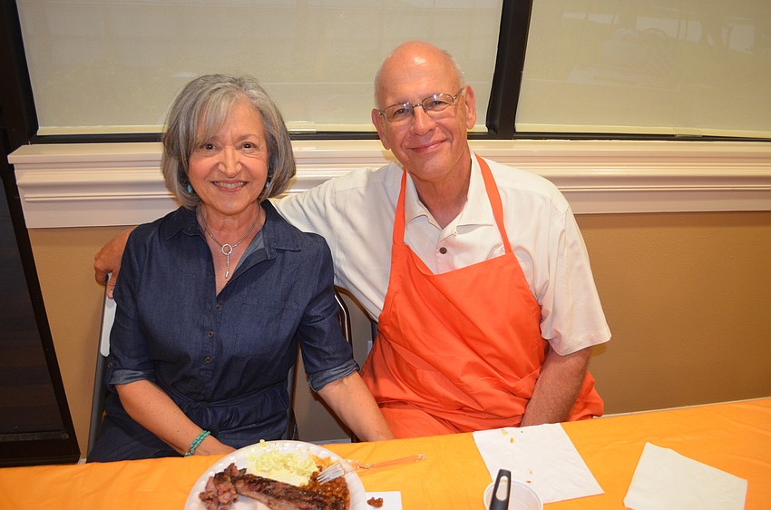 Barbara and Richard Williams serve up barbecue food to guests.