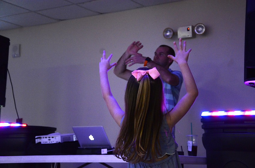 Gianna Johnson plays along with Kidman DJ Mike Wilder to an 