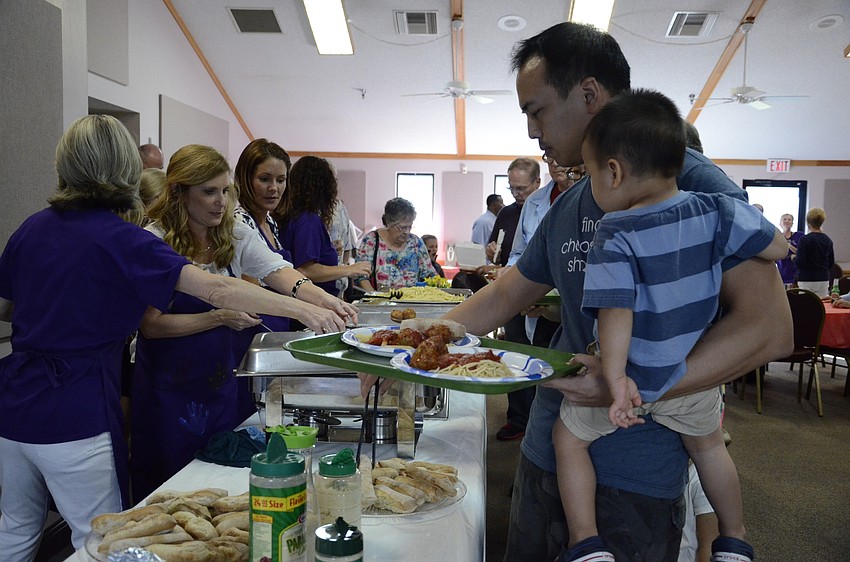 Kevin and Matthew Lo load up their trays with some spaghetti.