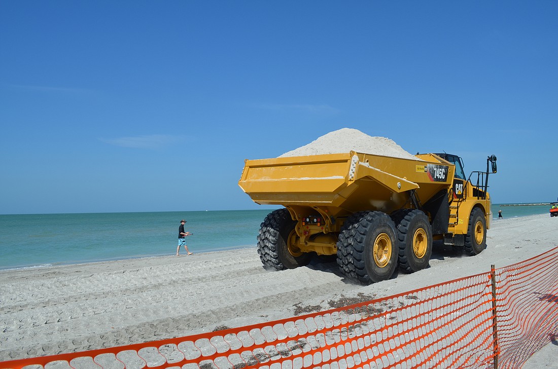 Your Observer Photo A dump truck makes the first of two trips to deliver sand from Immokalee