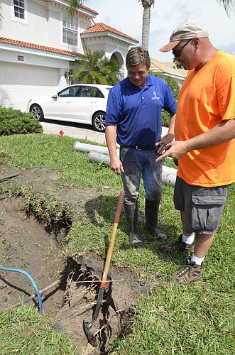 Lakewood Ranch Town Hall Operations Department employees John Stewart and Travis Boyens look at piping in the soft dig site on U.S. Open Way. Photo by Jessica Salmond.